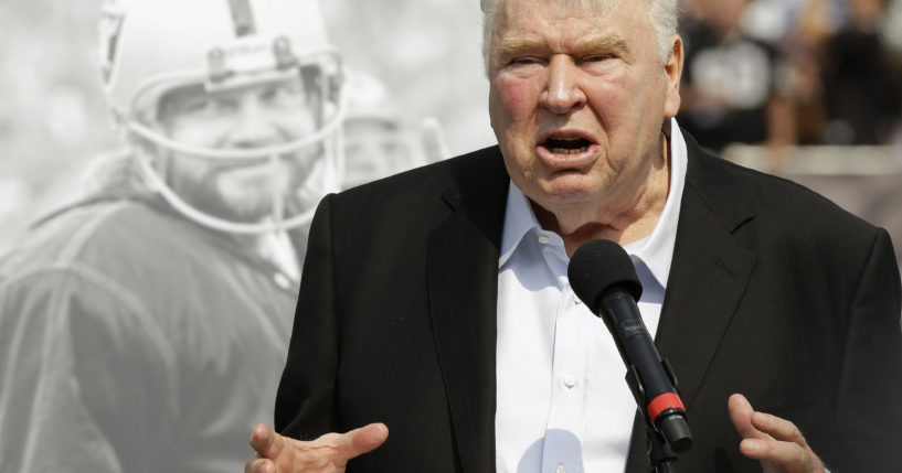 Former Oakland Raiders head coach John Madden speaks about former quarterback Ken Stabler, pictured at rear, at a ceremony honoring Stabler during halftime of an NFL football game between the Raiders and the Cincinnati Bengals in Oakland, California, on Sept. 13, 2015.