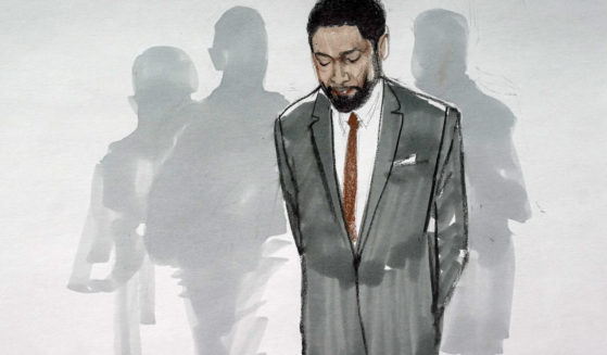 In this courtroom sketch, actor Jussie Smollett stands with his legal team in a Leighton Criminal Courthouse courtroom in Chicago, Illinois, on Dec. 9 after a jury found him guilty on five of six charges he staged a racist, anti-gay attack on himself and lied to police about it.