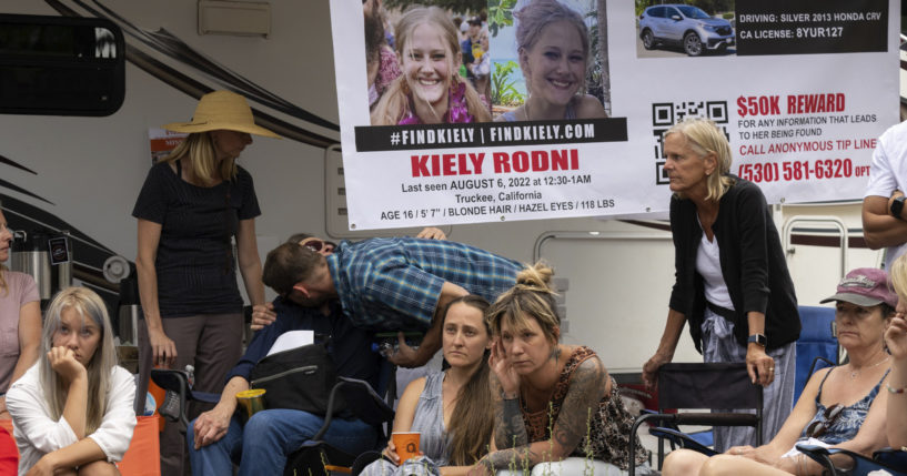 On Aug. 9, law enforcement officials give a news conference on missing 16-year-old Kiely Rodni, while her mother Lindsey Rodni-Nieman, center, listens.