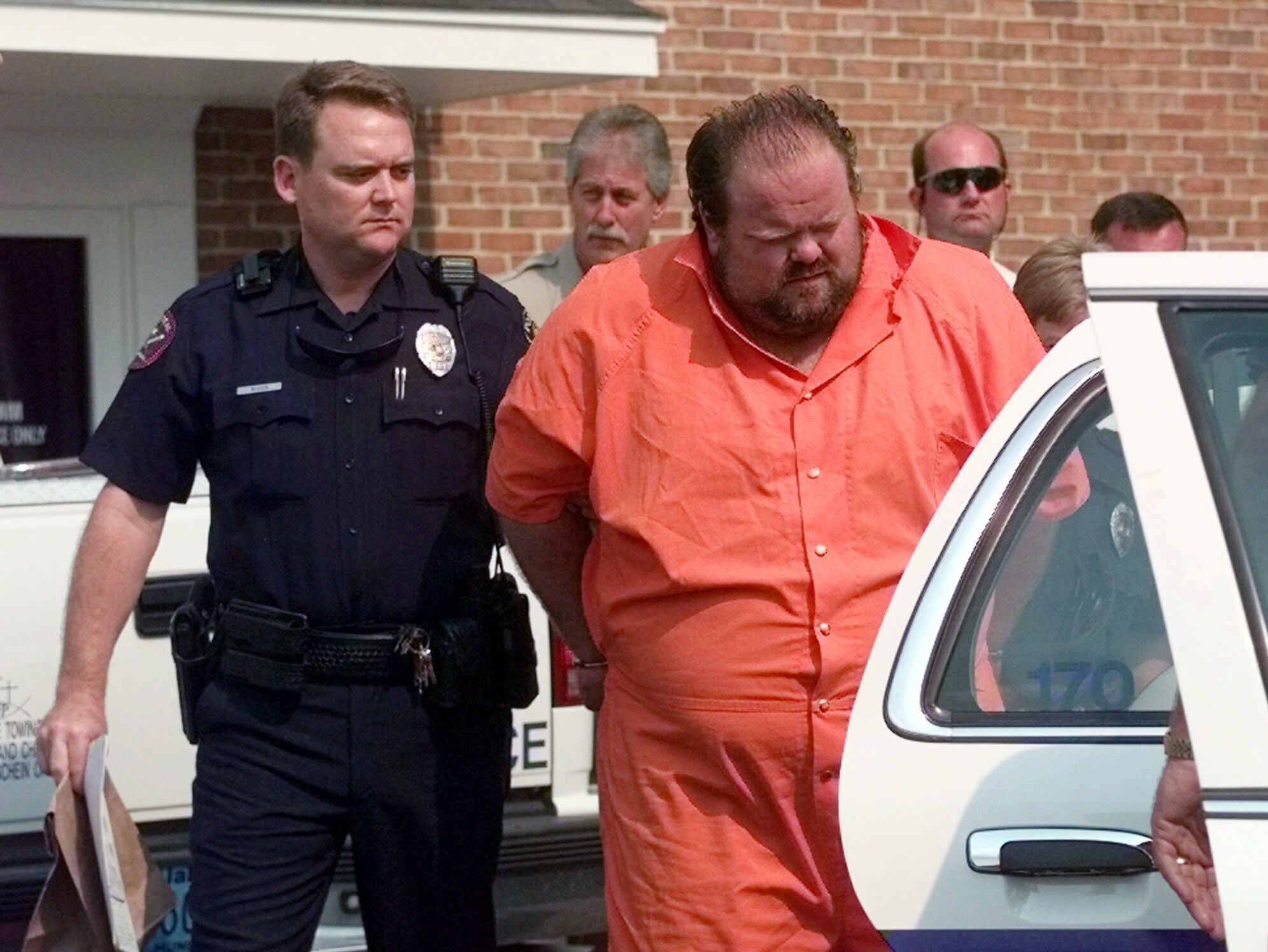 Officials escort murder suspect Alan Miller from the Pelham City Jail in Alabama on Aug. 5, 1999. Miller was scheduled to be put to death by lethal injection on Thursday for a workplace shooting rampage in 1999 that killed three men.