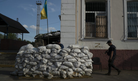 On Sunday, a man with the State of Emergency Service of Ukraine enters the basement of a train station that is fortified with sand bags, which was used as an interrogation room during Russian occupation, in Kozacha Lopan, Ukraine.