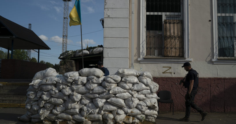 On Sunday, a man with the State of Emergency Service of Ukraine enters the basement of a train station that is fortified with sand bags, which was used as an interrogation room during Russian occupation, in Kozacha Lopan, Ukraine.