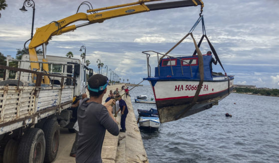 On Monday, workers move a boat out from the water in the bay of Havana, Cuba, as Hurricane Ian prepared to hit Cuba.