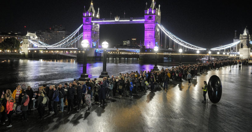 People queue in front of London's Tower Bridge early Saturday morning to pay their respects to the late Queen Elizabeth II at Westminster Hall. Waiting time in the queue has stretched to as long as 24 hours.