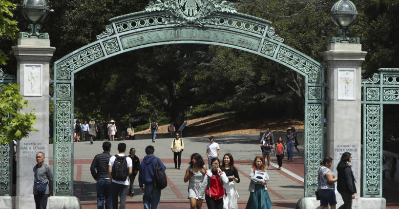 Students at the University of California at Berkeley in Berkeley, California, walk through the Sather Gate on May 10, 2018.