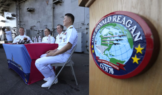 Rear Adm. Michael Donnelly, commander of the carrier strike group, second from right, listens to a reporter's question during a news conference on the deck of the nuclear-powered aircraft carrier USS Ronald Reagan in Busan, South Korea.