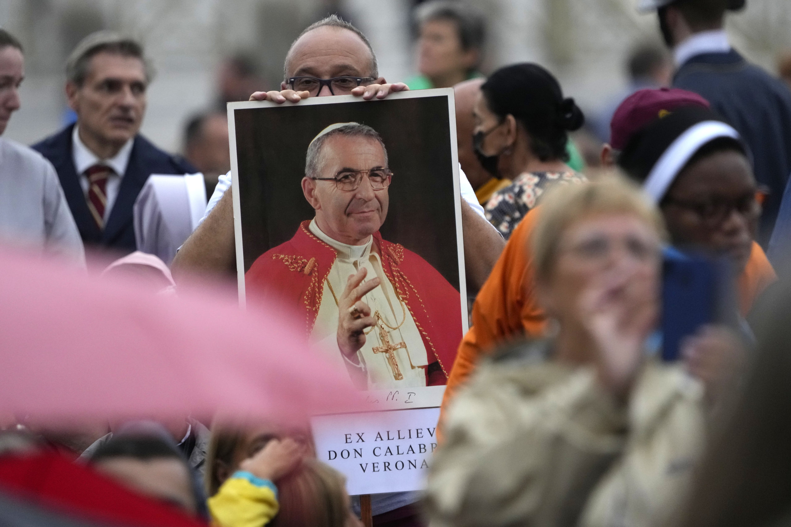 A man holds up a photograph of Pope John Paul I during his beatification ceremony in St. Peter's Square at the Vatican on Sunday.