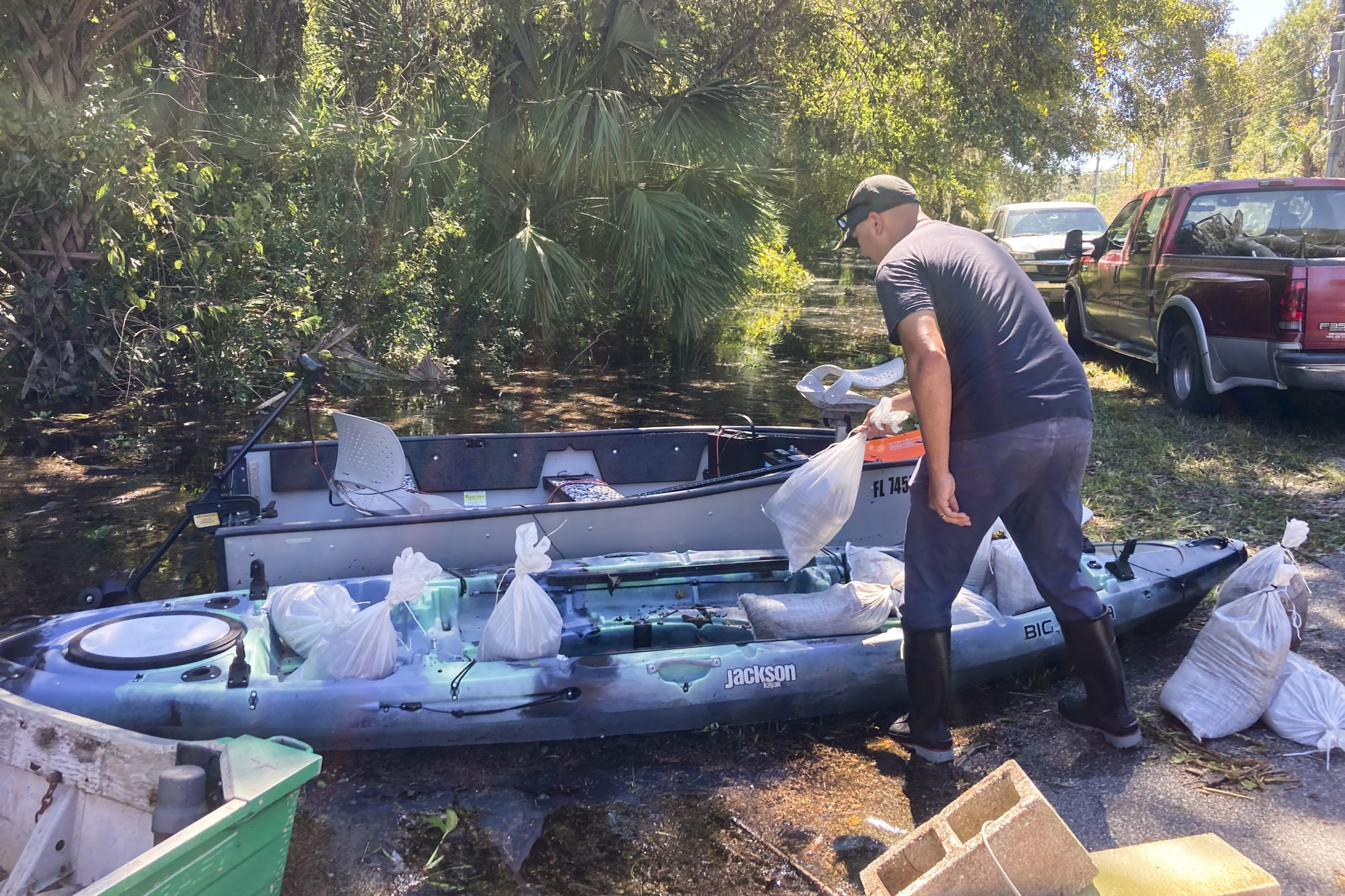 On Sunday, Gabriel Madling, a resident of Seminole County, Florida, loads sandbags into a kayak, so he can fortify his house from floodwaters left behind by Hurricane Ian.