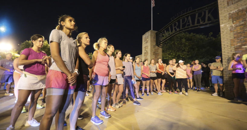 Members of the Tupelo Running Club and others gather for a moment of silence before their "Liza's Lights" run, in honor of Eliza Fletcher, on the morning of Sept. 9.