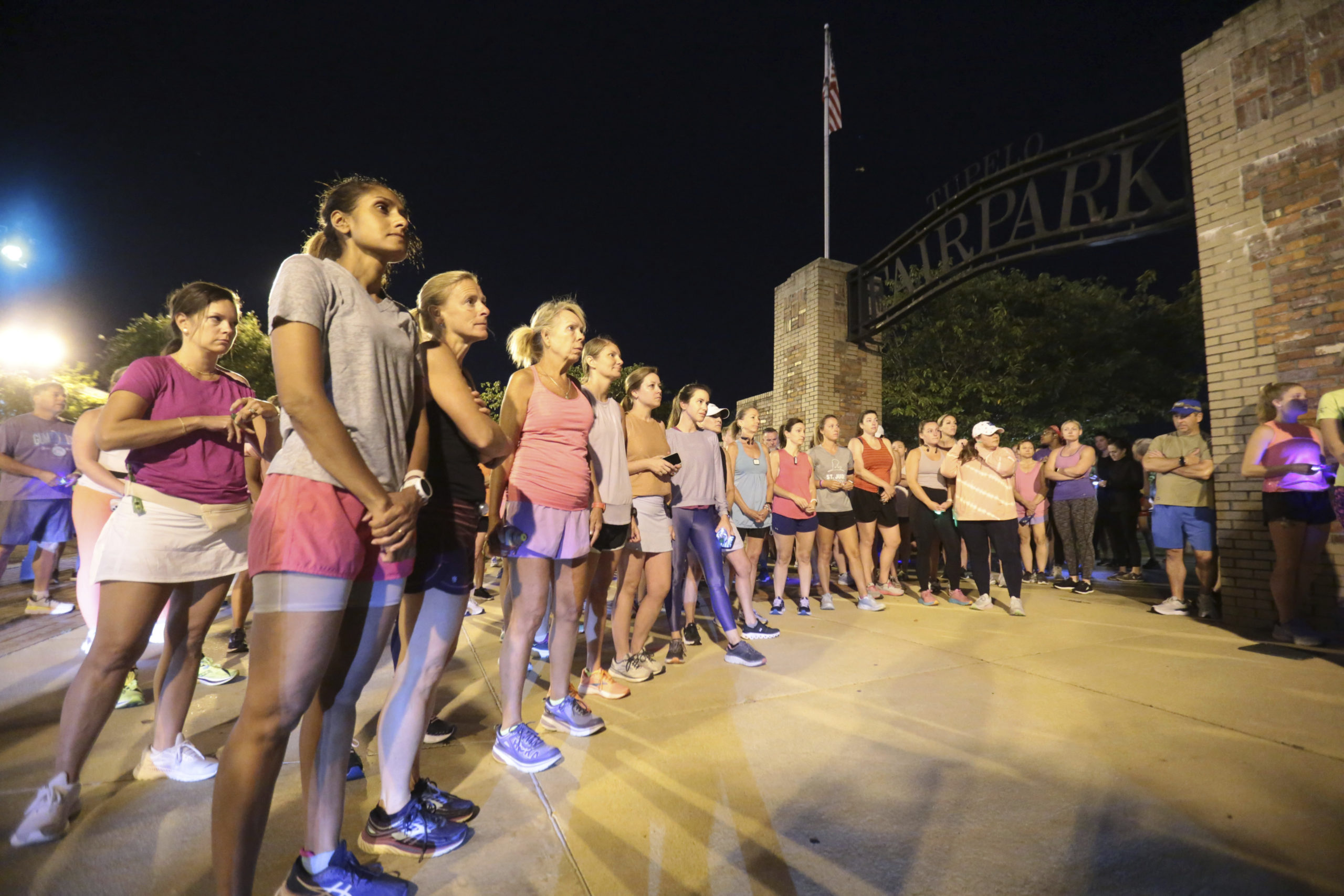 Members of the Tupelo Running Club and others gather for a moment of silence before their "Liza's Lights" run, in honor of Eliza Fletcher, on the morning of Sept. 9.