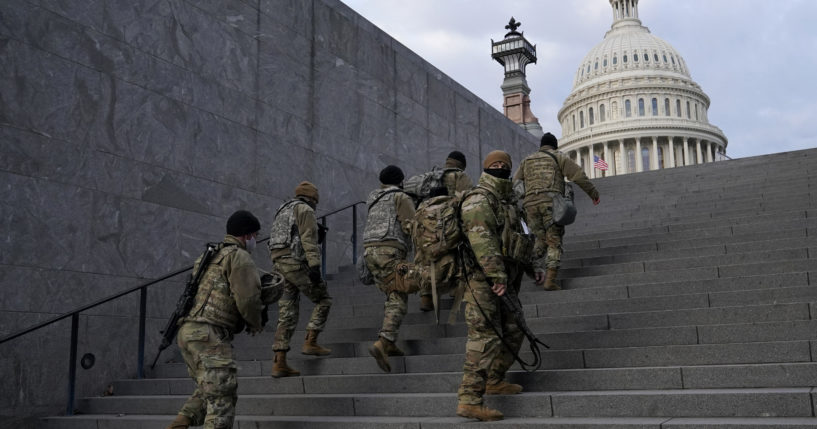 National Guard members take a staircase toward the U.S. Capitol building before a rehearsal for President-elect Joe Biden's inauguration in Washington, D.C., on Jan. 18, 2021.