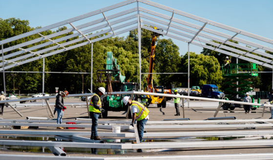 Workers build a hanger-sized tent as a temporary shelter for illegal immigrants in the Bronx, New York, on Sept. 27.