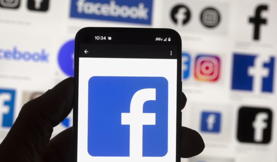 The Facebook logo is seen on a cellphone this month in Boston. A Washington state judge on Wednesday fined Facebook parent company Meta nearly $25 million.