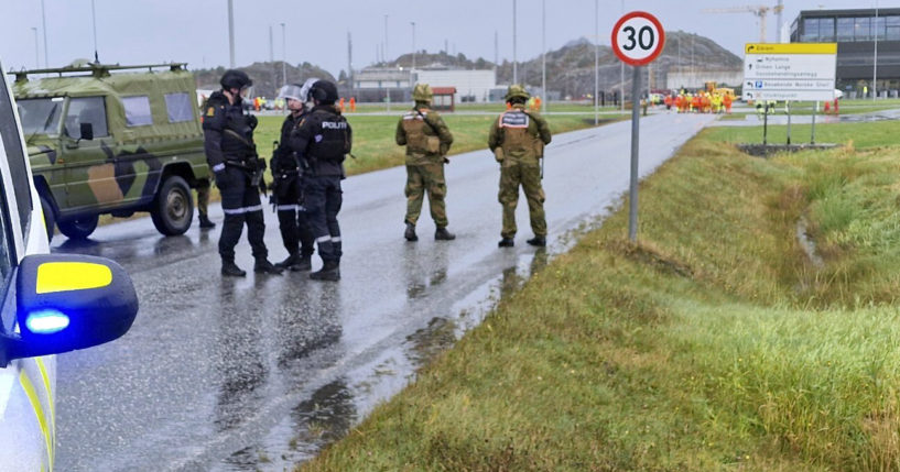 Police and personnel from the Home Guard stand guard outside the land plant of the Ormen Lange gas field after a person called in a bomb threat against the plant in Aukra, Norway, on Thursday.