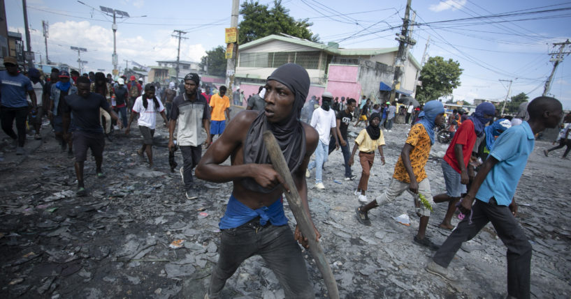 Protesters move through the streets in Port-au-Prince, Haiti, demanding the resignation of Prime Minister Ariel Henry on Monday.