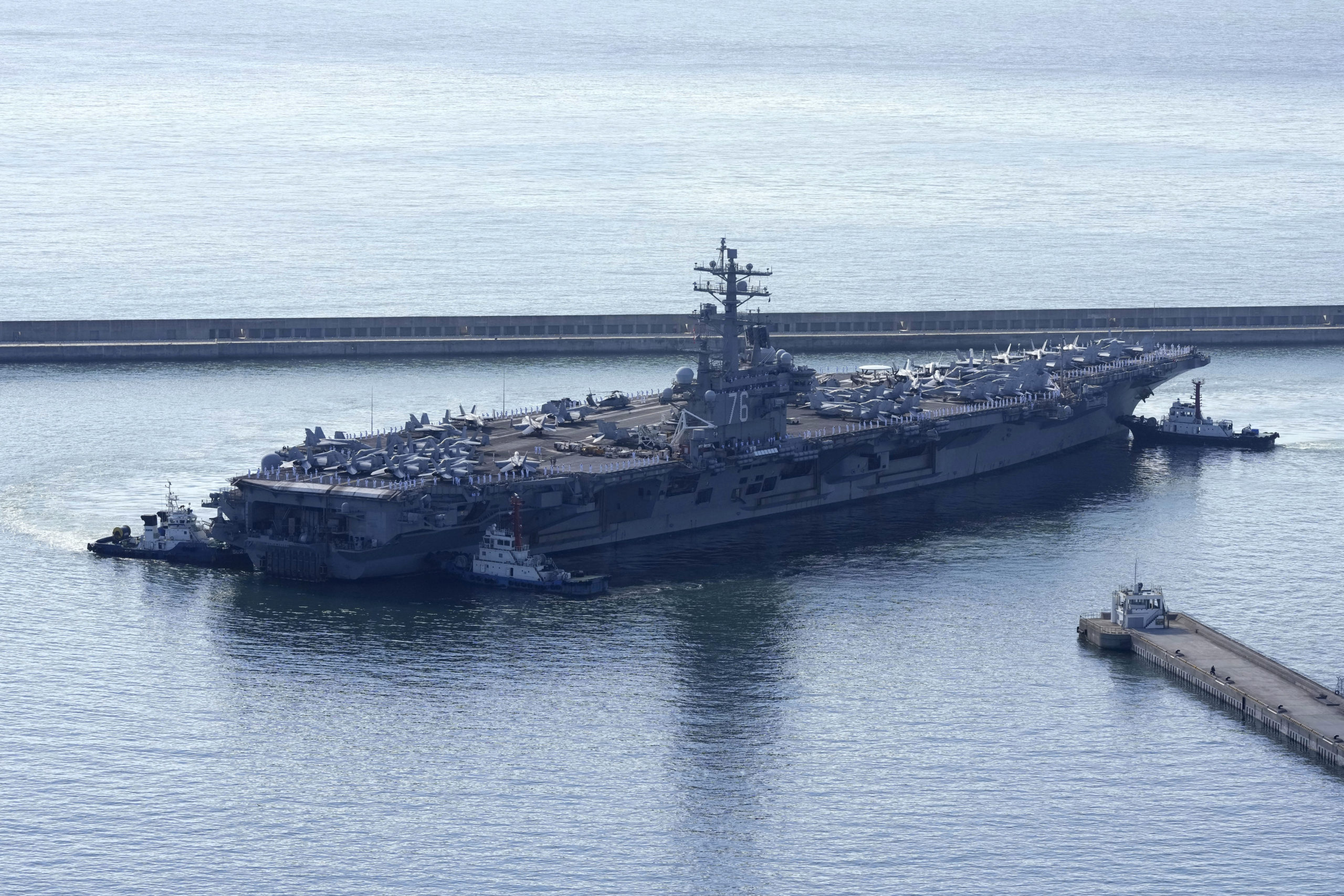 The U.S. carrier USS Ronald Reagan is escorted as it arrives in Busan, South Korea on Sept. 23.