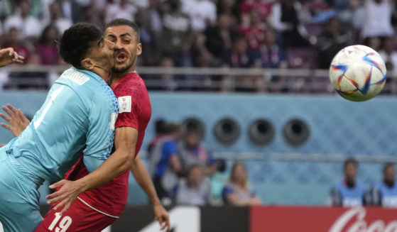 Iran's goalkeeper Alireza Beiranvand collides with teammate Majid Housseini during the World Cup game between Iran and England in Doha, Qatar, on Monday.