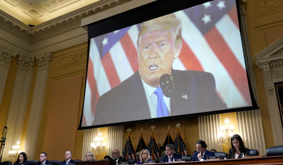 A video of former President Donald Trump is shown on a screen, as the House Jan. 6 committee holds its final meeting on Capitol Hill on Dec. 19.