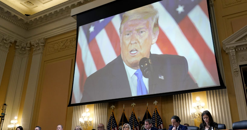 A video of former President Donald Trump is shown on a screen, as the House Jan. 6 committee holds its final meeting on Capitol Hill on Dec. 19.