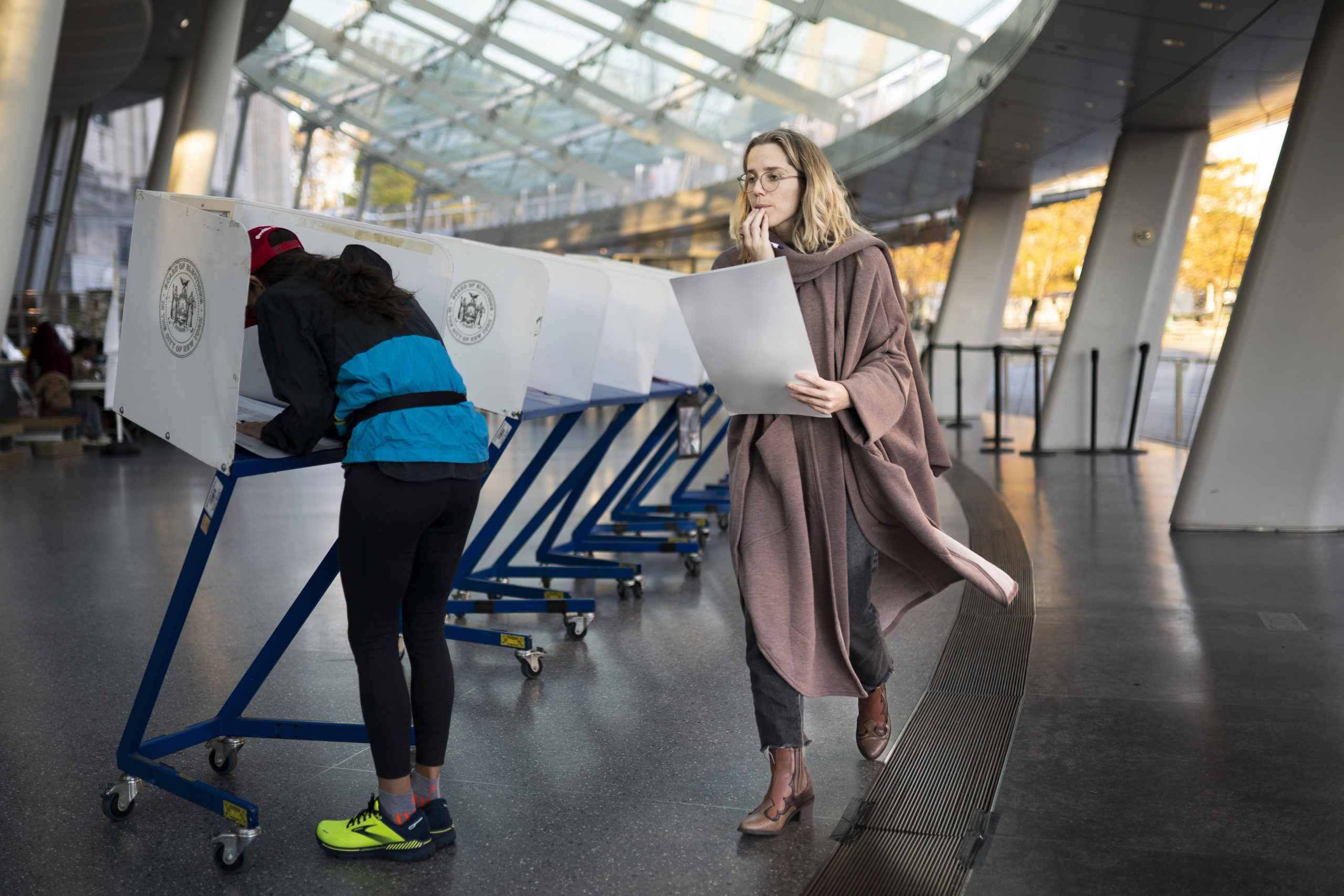 A voter moves to cast her ballot at an electronic counting machine at a polling site in the Brooklyn Museum on Nov. 8 in the Brooklyn borough of New York.