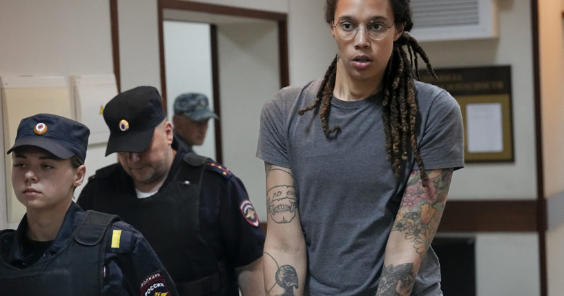 WNBA star and two-time Olympic gold medalist Brittney Griner is seen in an August file photo being escorted from a courtroom near Moscow. Russia freed Griner on Thursday in a dramatic high-level prisoner exchange, with the U.S. releasing notorious Russian arms dealer Viktor Bout.