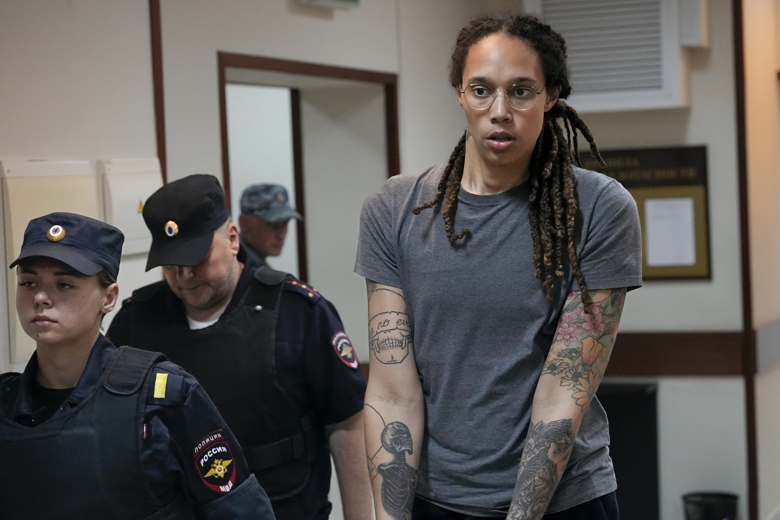 WNBA star and two-time Olympic gold medalist Brittney Griner is seen in an August file photo being escorted from a courtroom near Moscow. Russia freed Griner on Thursday in a dramatic high-level prisoner exchange, with the U.S. releasing notorious Russian arms dealer Viktor Bout.