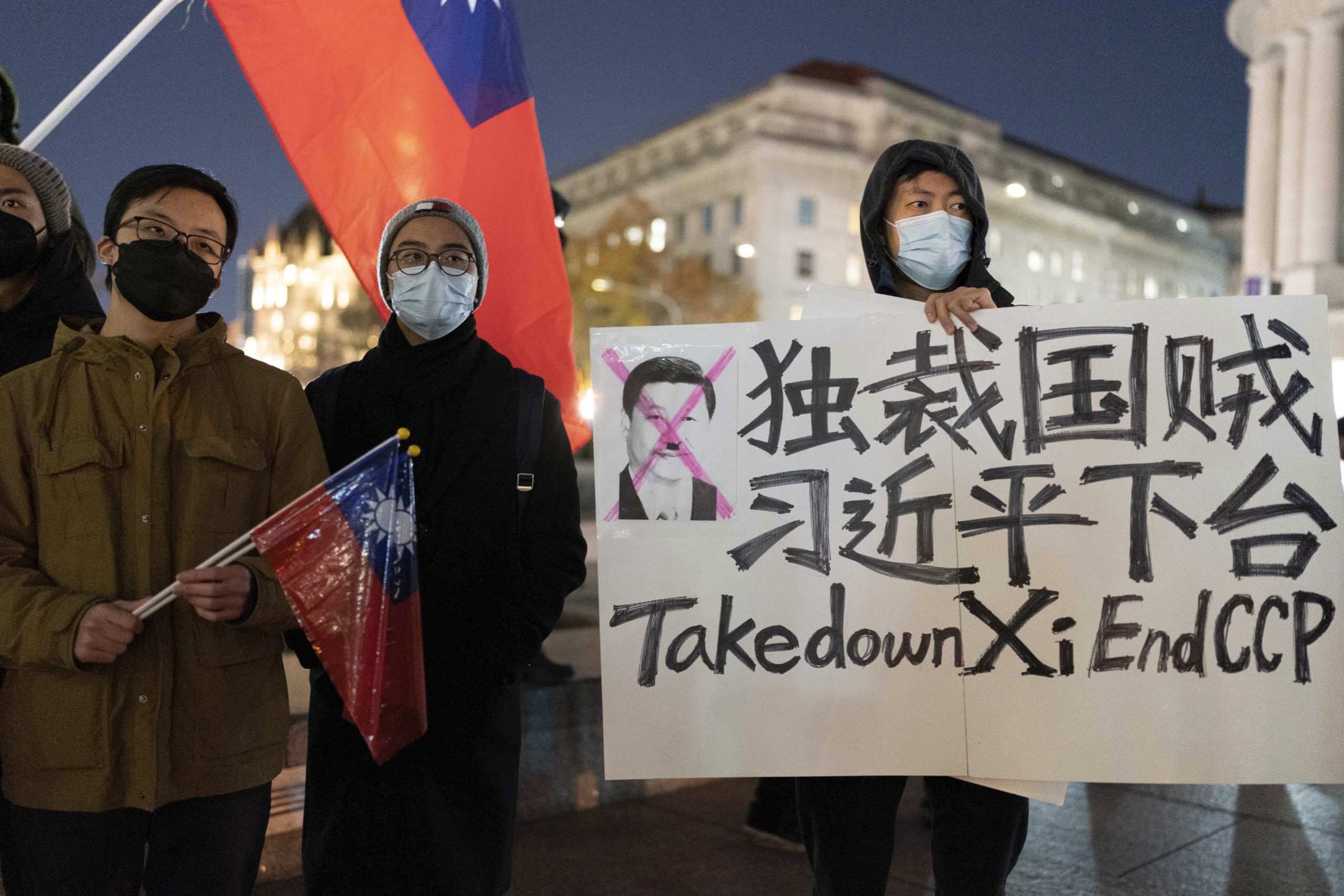 A demonstrator holds a sign to protest in solidarity with the Chinese protests at Freedom Plaza in Washington, D.C., on Sunday.