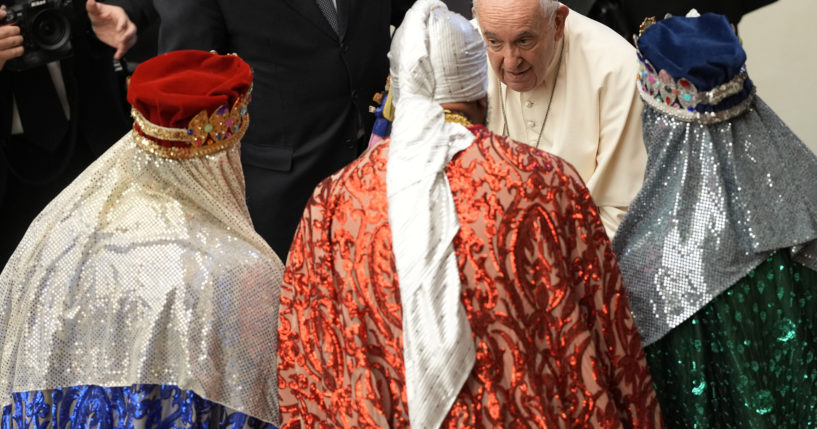 Pope Francis talks to men dressed as the three wise men at the end of his weekly general audience in the Paul VI Hall at the Vatican on Wednesday.