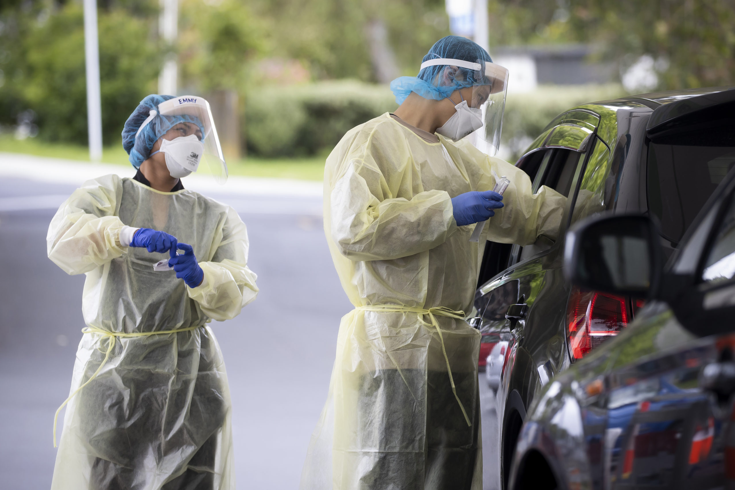 Technicians work to take samples as a community COVID testing center in Auckland, New Zealand on Dec. 28, 2021.