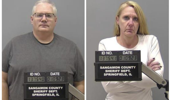 Ambulance workers Peter J. Cadigan, left, and Peggy Jill Finley are facing first-degree murder charges and now a civil lawsuit over the death of a patient they are accused of strapping face down on a stretcher while taking him to a hospital Dec. 18.