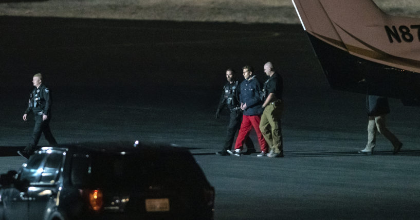 Bryan Kohberger is escorted by law enforcement after arriving at Pullman-Moscow Regional Airport in Pullman, Washington, on Thursday.