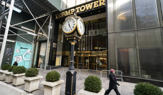 A pedestrian passes security barricades in front of Trump Tower in New York City in 2021. The Trump Organization on Friday was fined $1.61 million, not even enough to buy a Trump Tower apartment.