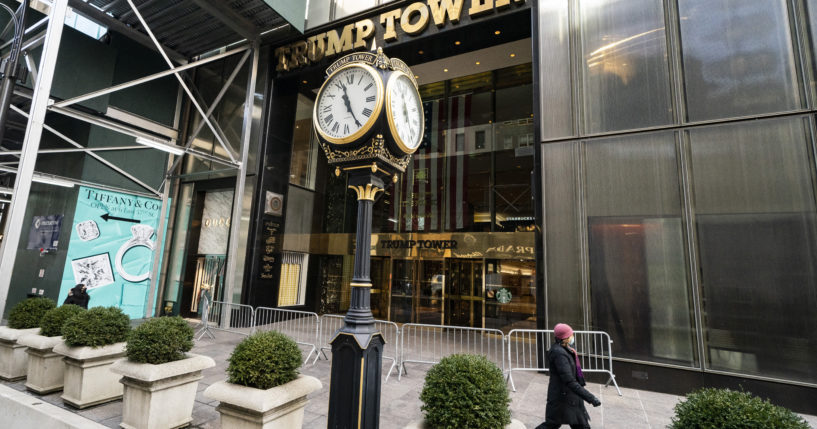 A pedestrian passes security barricades in front of Trump Tower in New York City in 2021. The Trump Organization on Friday was fined $1.61 million, not even enough to buy a Trump Tower apartment.