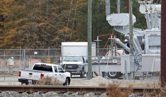 Workers work on equipment at the West End Substation in West End, North Carolina, on Dec. 5, 2022, where a serious attack on critical infrastructure caused a power outage to many around Southern Pines.