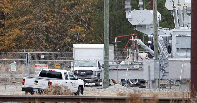 Workers work on equipment at the West End Substation in West End, North Carolina, on Dec. 5, 2022, where a serious attack on critical infrastructure caused a power outage to many around Southern Pines.