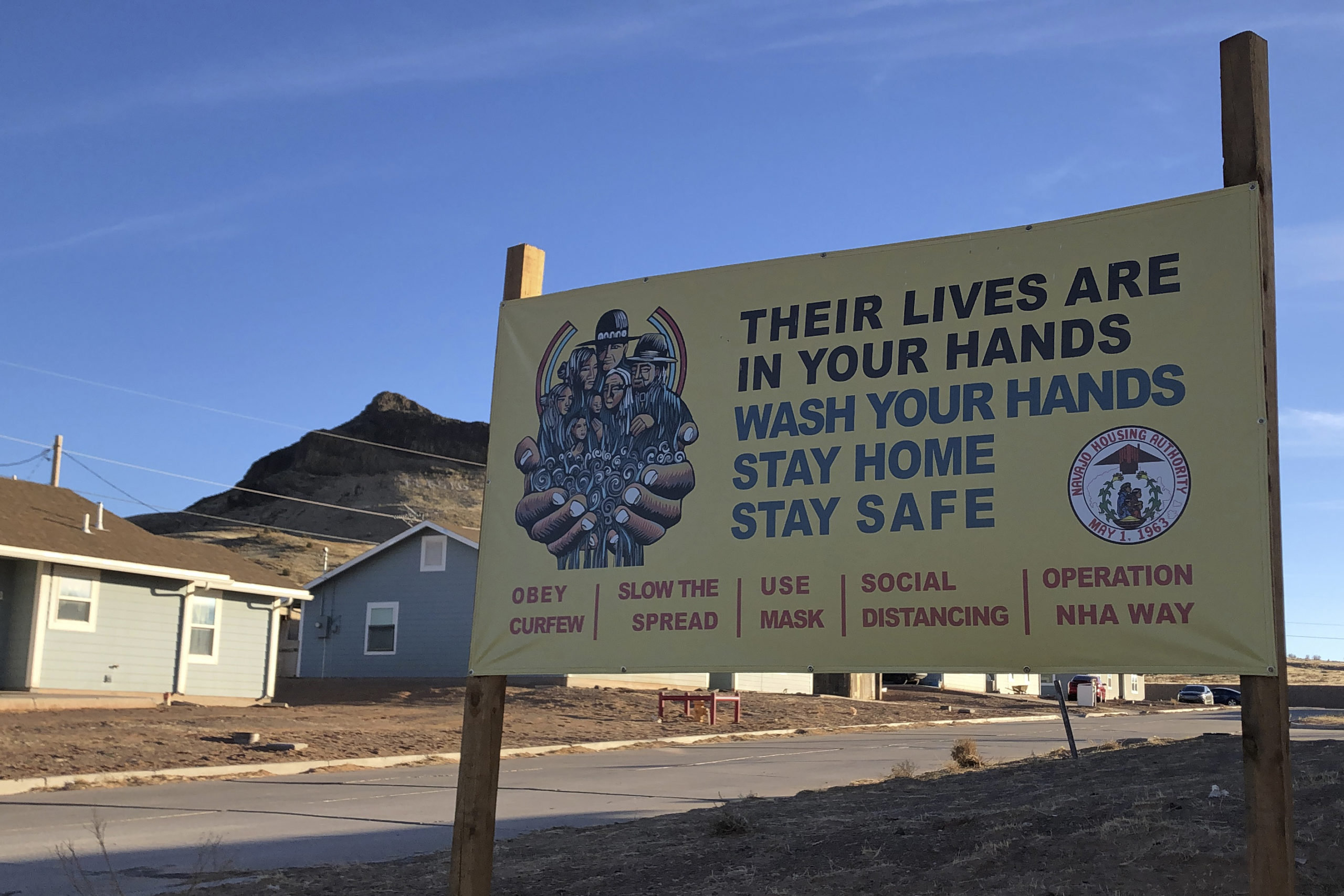 A sign urging safety measures during the coronavirus pandemic is displayed in Teesto, Arizona, on the Navajo Nation on Feb. 11, 2021.