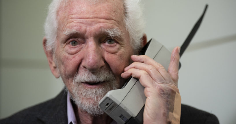 Marty Cooper, inventor of the first commercial cellphone, poses with a Motorola DynaTAC 8000X during an AP interview in Barcelona, Spain, on Monday.