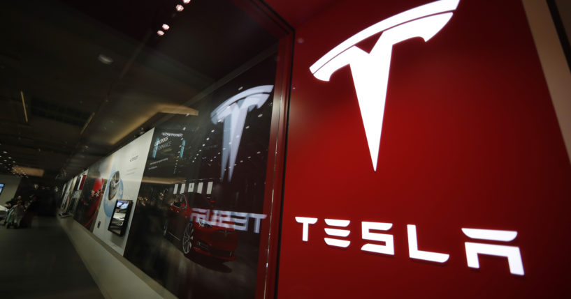 A sign bearing the company logo outside a Tesla store in Cherry Creek Mall in Denver, Colorado is pictured on Feb. 9, 2019.