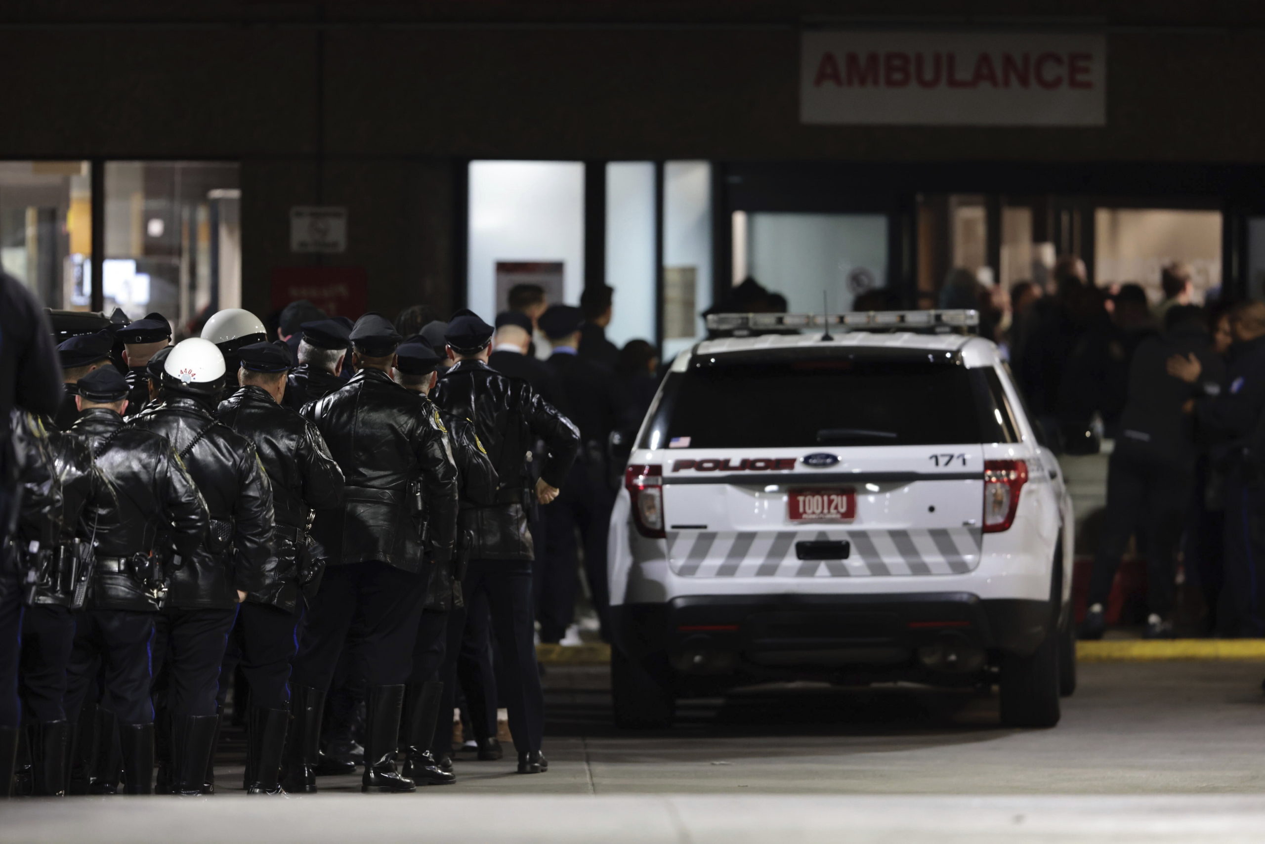 Police gather at Temple University Hospital following a fatal shooting of a Temple University police officer near the campus in Philadelphia on Saturday.