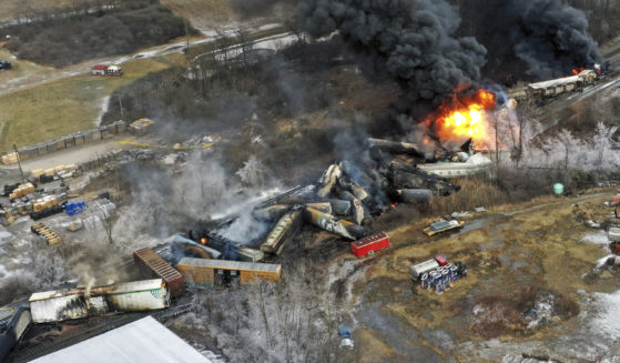 portions of a Norfolk and Southern freight train that derailed still burning