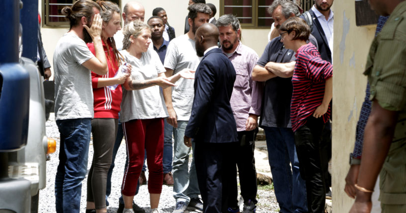 Eight Croatian nationals, who were charged, again, with child trafficking in Zambia, stand outside the magistrates court in Ndola on Jan. 10.