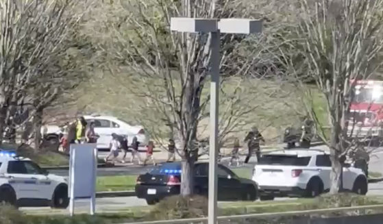 Law enforcement officers lead children away from the scene of a shooting at The Covenant School, a private Christian school in Nashville on Monday.