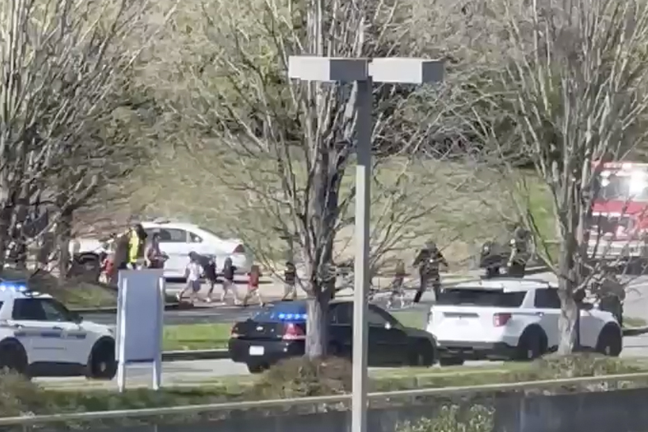 Law enforcement officers lead children away from the scene of a shooting at The Covenant School, a private Christian school in Nashville on Monday.