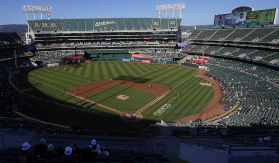 Spectators watch a baseball game between the Oakland Athletics and the Texas Rangers at the Oakland Coliseum in Oakland, California, on July 23, 2022.