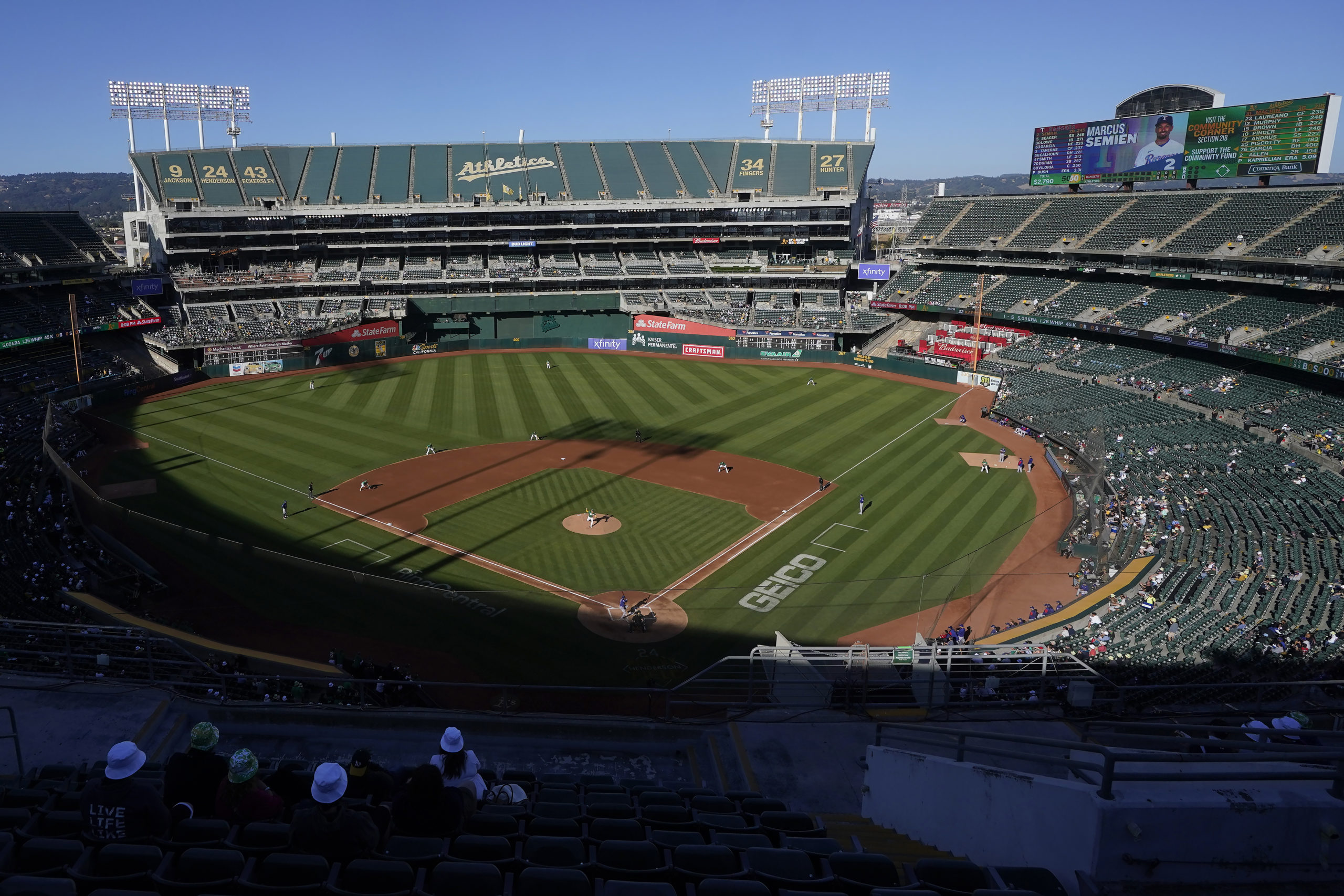 Spectators watch a baseball game between the Oakland Athletics and the Texas Rangers at the Oakland Coliseum in Oakland, California, on July 23, 2022.