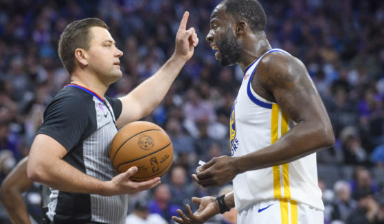 Golden State Warrior forward Draymond Green, right, argues with referee Gediminas Petraitis during the first half of game 2 of the NBA playoffs against the Sacramento Kings in Sacramento, California, on Monday.