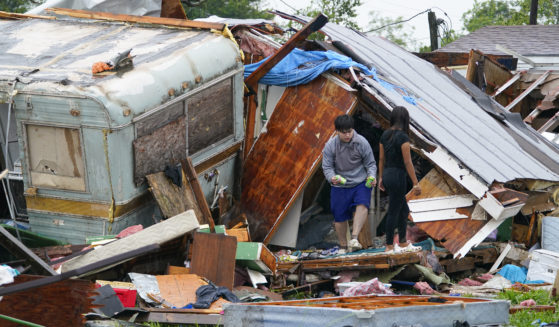 A person stands outside of a damaged home after a tornado hit on Saturday in Laguna Heights, Texas, near South Padre Island. Authorities say one person was killed and several were injured when the tornado struck the southernmost tip of Texas on the Gulf Coast.