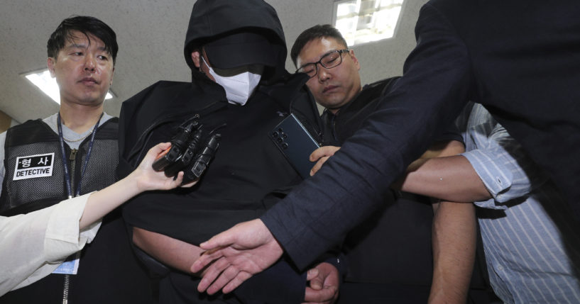 A man who opened an emergency exit door during a flight, arrives to attend an arrest warrant review at the Daegu District Court in Daegu, South Korea, on Sunday.