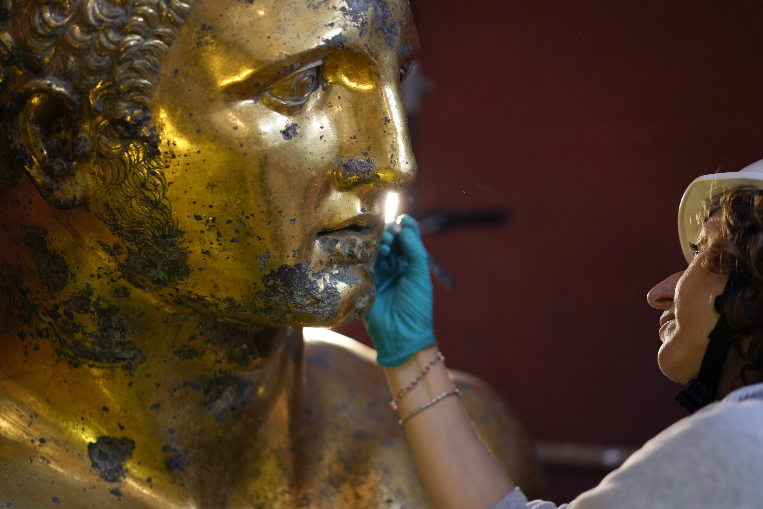 Vatican Museum restorer Alice Baltera works on the bronze Hercules statue in the Round Hall of the Vatican Museums on Thursday.