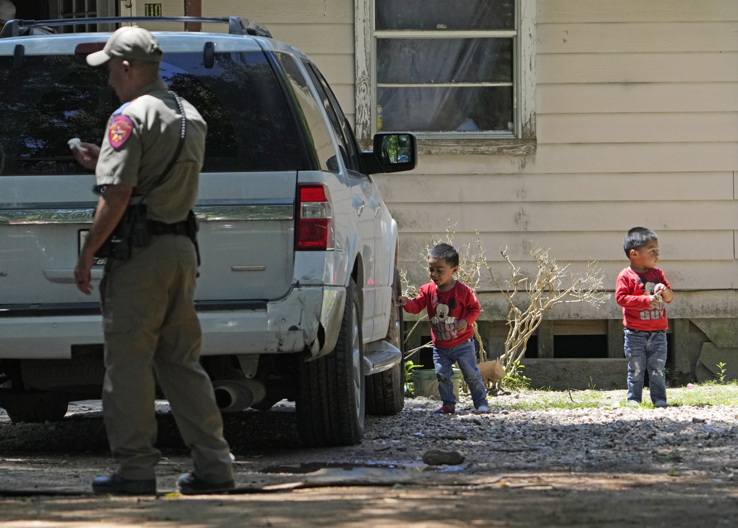 On Sunday, Josue, left, and Nathan Barcenas, right, play outside their home as law enforcement continues to investigate the neighborhood where a mass shooting occurred Friday night, in Cleveland, Texas.